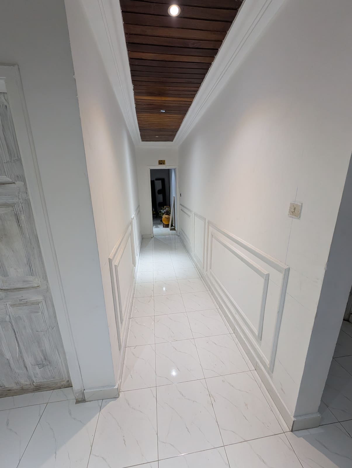 White wainscotting in the adjoining hallway