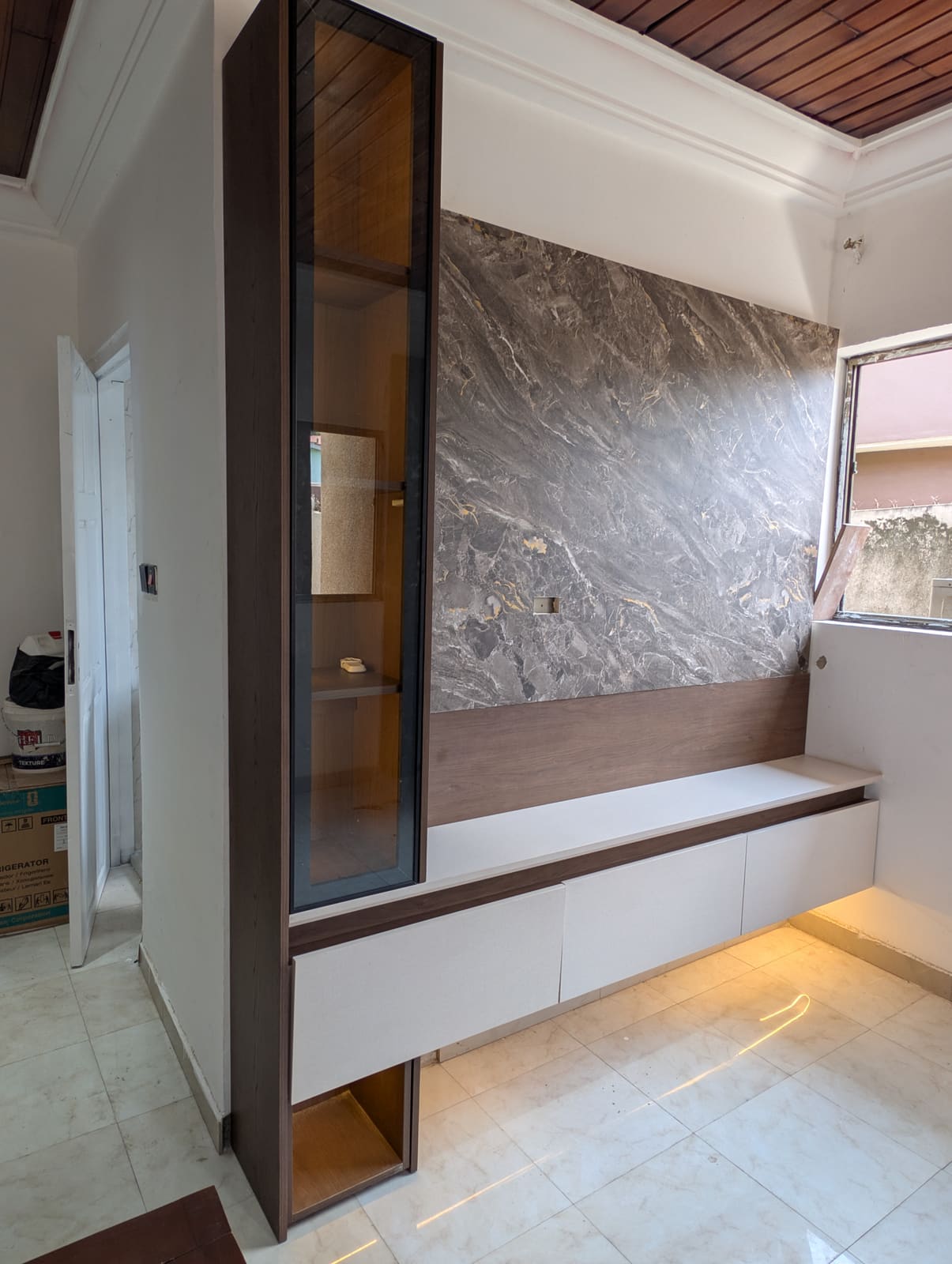 TV unit with marble feature wall and lit glass display cabinet, Achimota guesthouse
