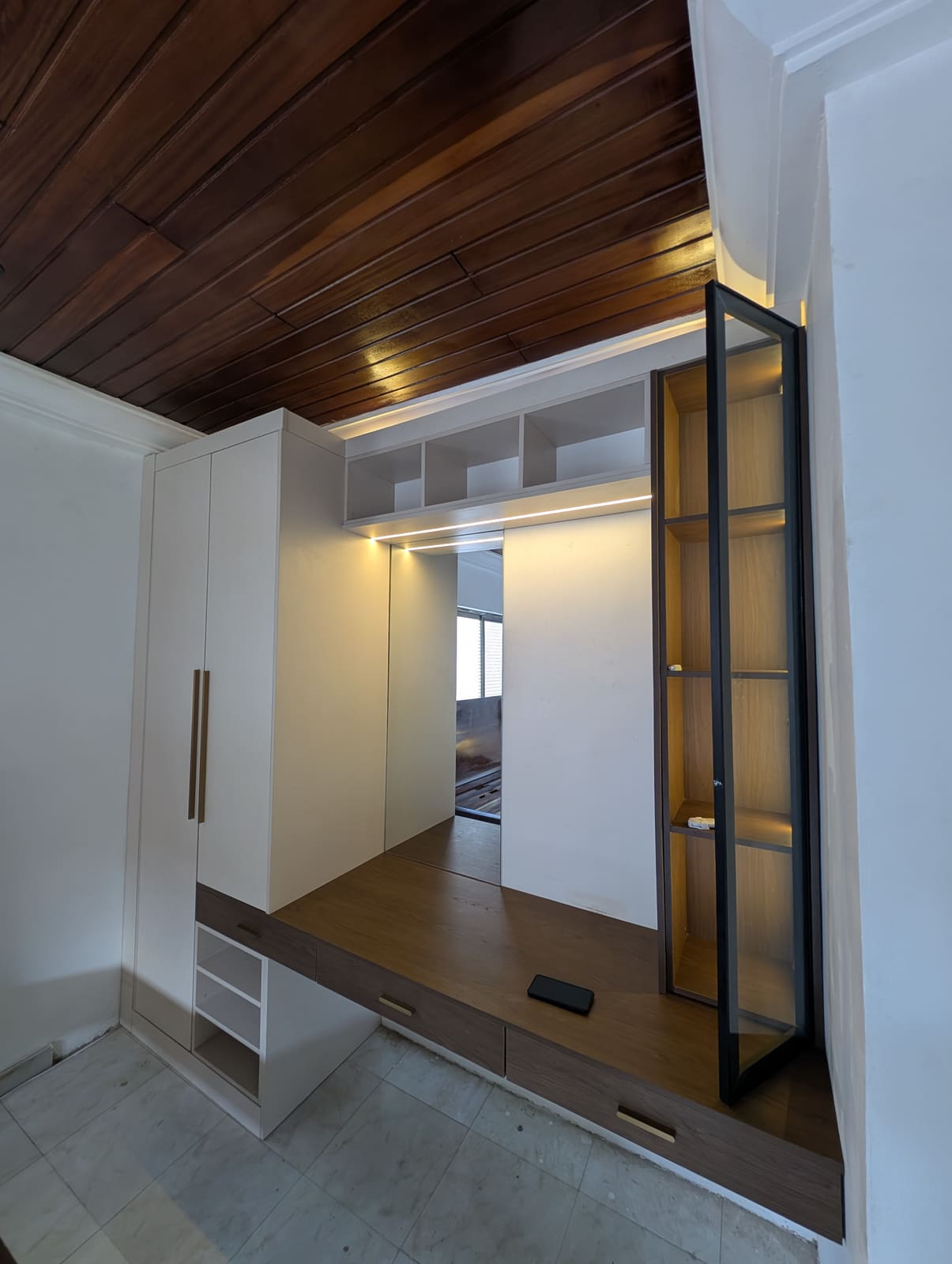 Built-in wardrobe with floating vanity desk and glass display cabinet, Achimota guesthouse