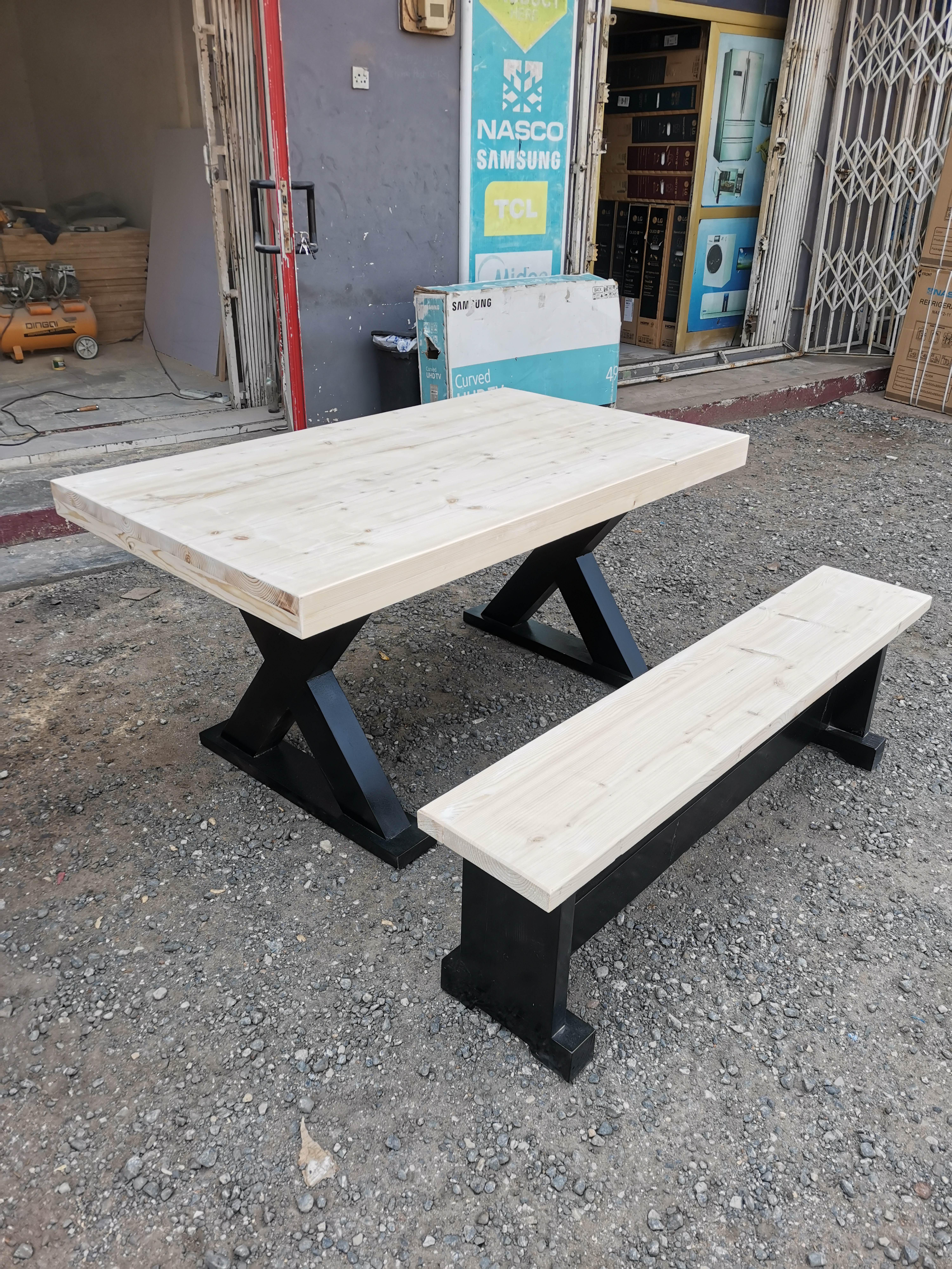 Raw unstained X-frame pine dining table before staining — Neewoody workshop