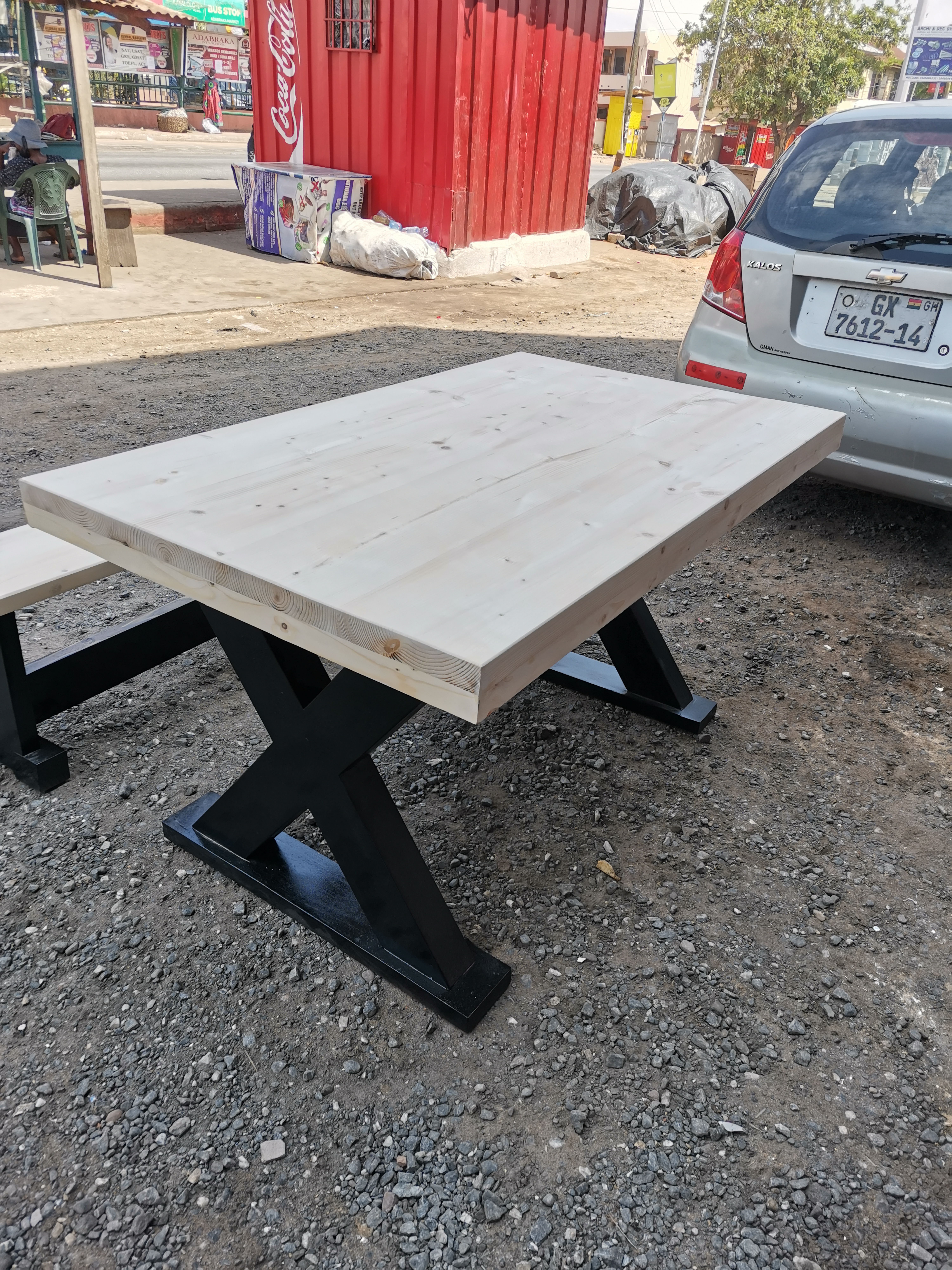 Freshly built X-frame pine dining table outdoors before delivery — Golf Hills Estate commission