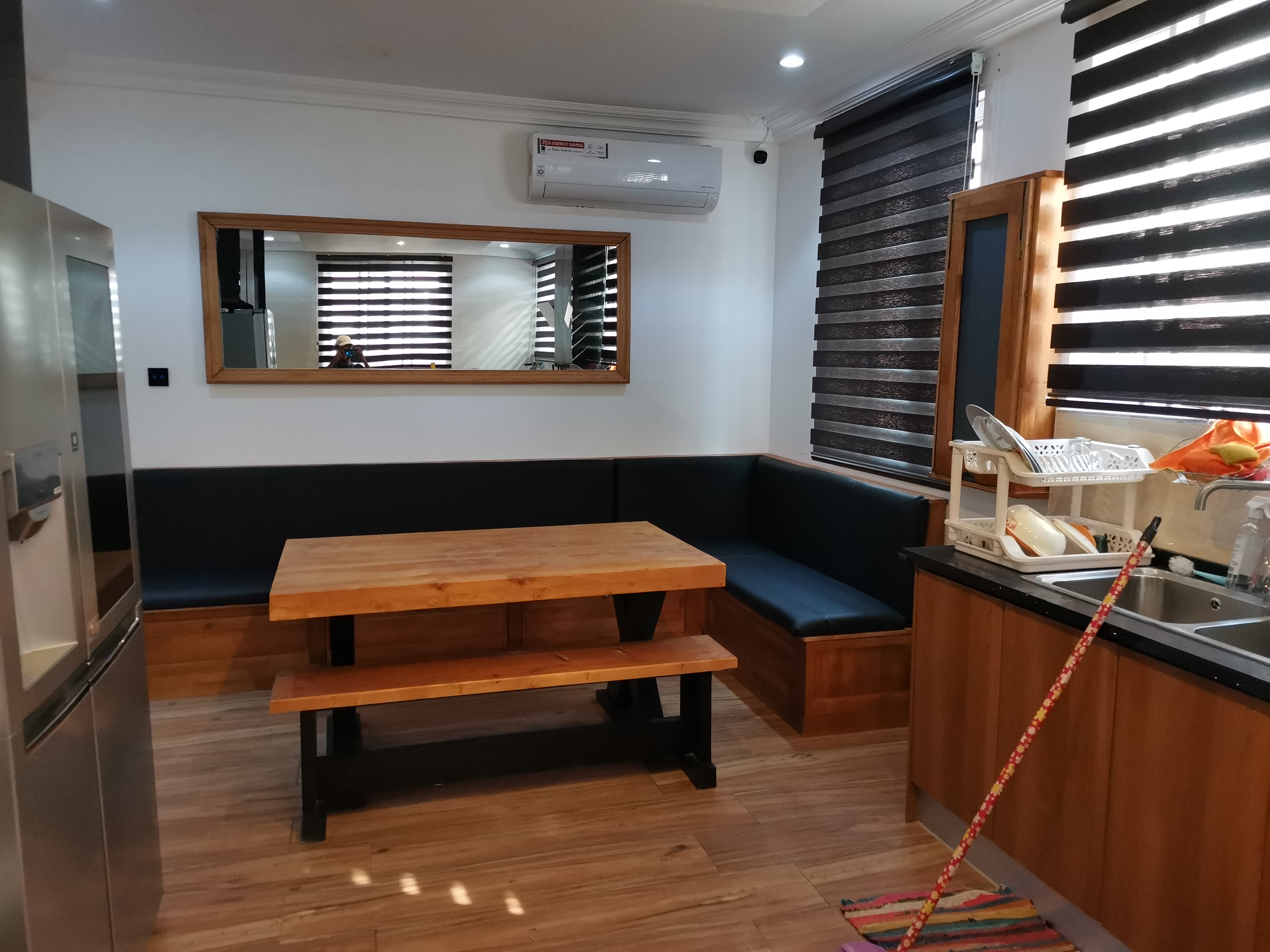 Golf Hills Estate — X-frame dining table and built-in banquette installed, wide view