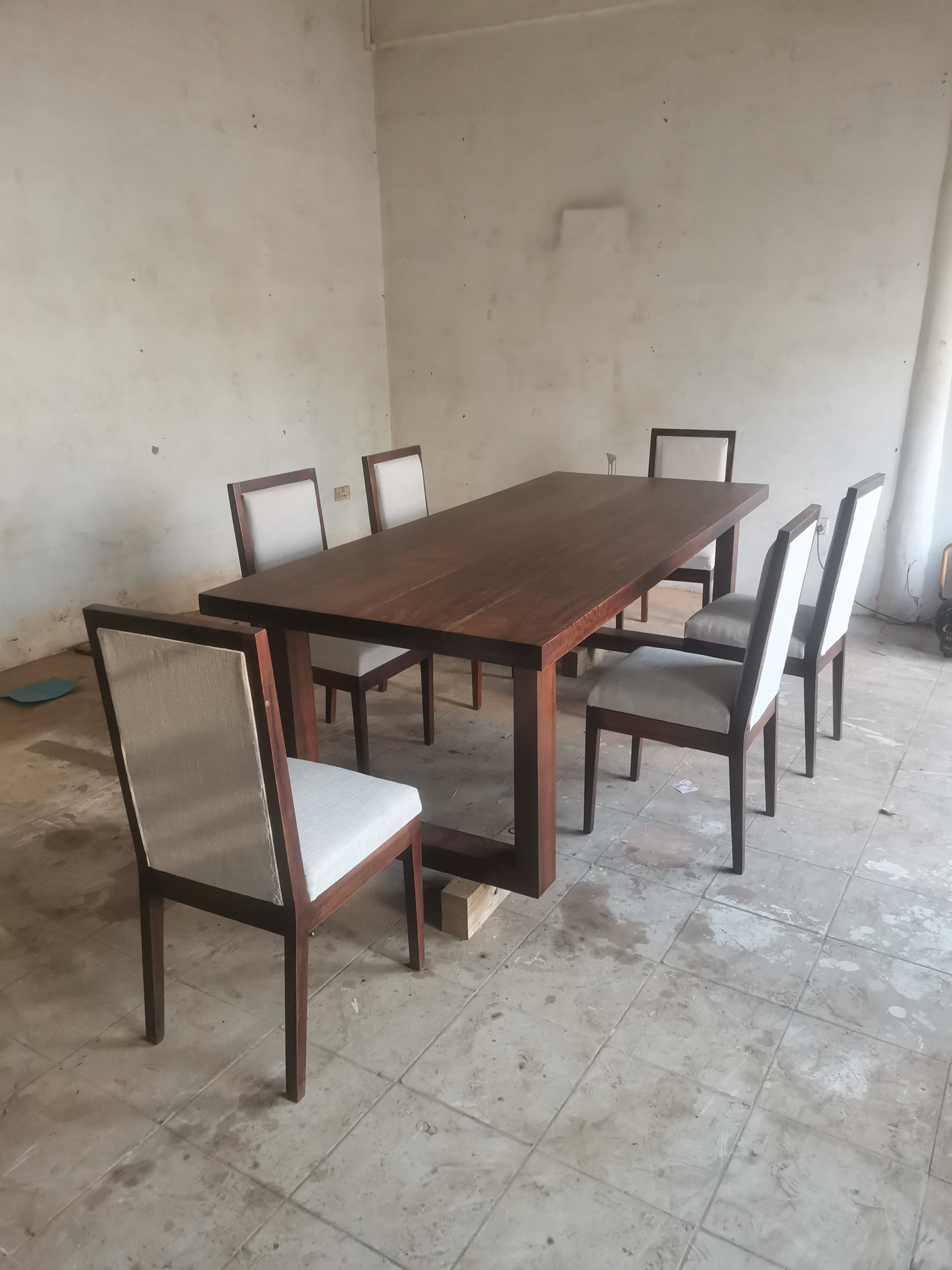 Hyedua dining set staged before delivery — table, chairs, and console unit in matched espresso finish